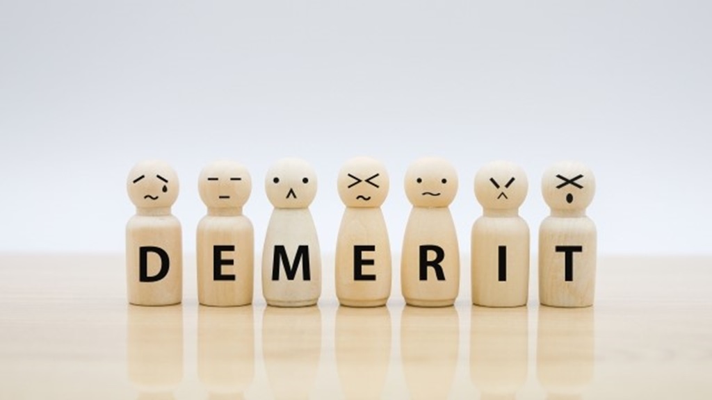 複数の人形で表現されるDEMERITの文字